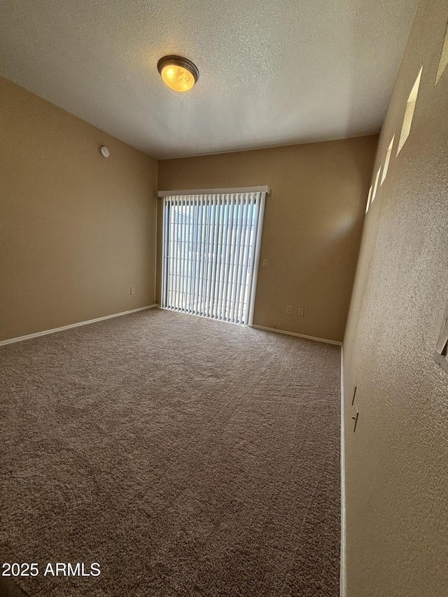 3434 E Baseline Rd Unit 204, Phoenix, AZ 85042 - carpeted spare room featuring a textured ceiling and baseboards