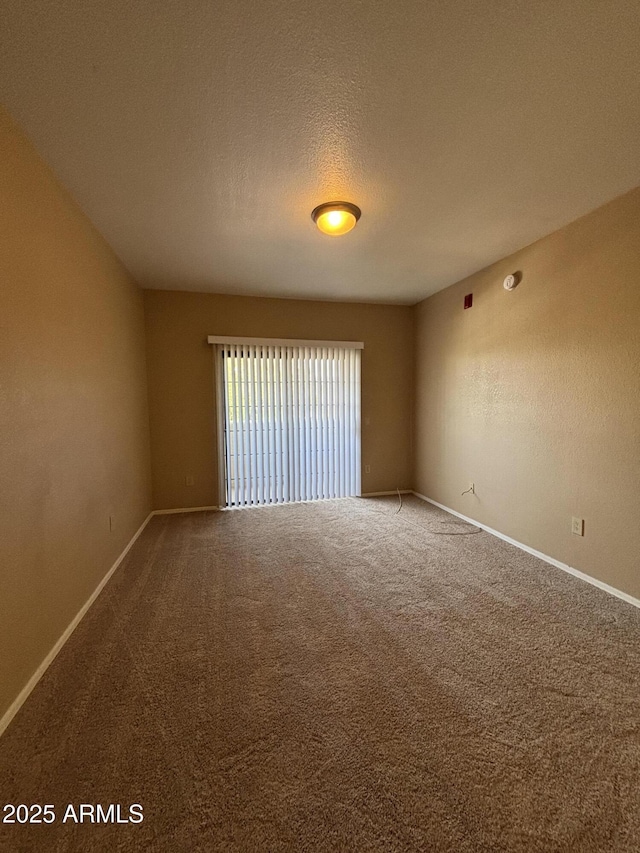 3434 E Baseline Rd Unit 204, Phoenix, AZ 85042 - carpeted spare room with baseboards and a textured ceiling