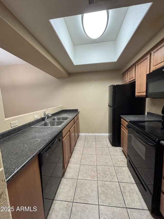 3434 E Baseline Rd Unit 204, Phoenix, AZ 85042 - kitchen featuring black appliances, a tray ceiling, dark countertops, light tile patterned flooring, and brown cabinetry