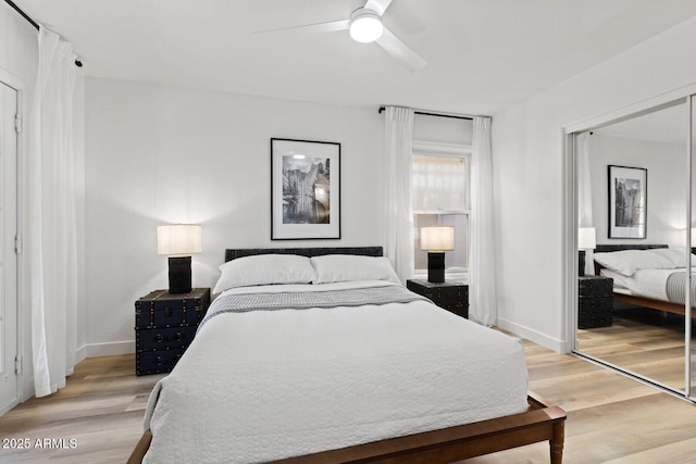 bedroom with ceiling fan, a closet, and hardwood / wood-style flooring