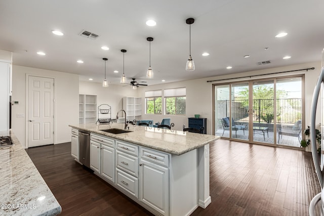 kitchen featuring white cabinets, dark wood-type flooring, a healthy amount of sunlight, and sink