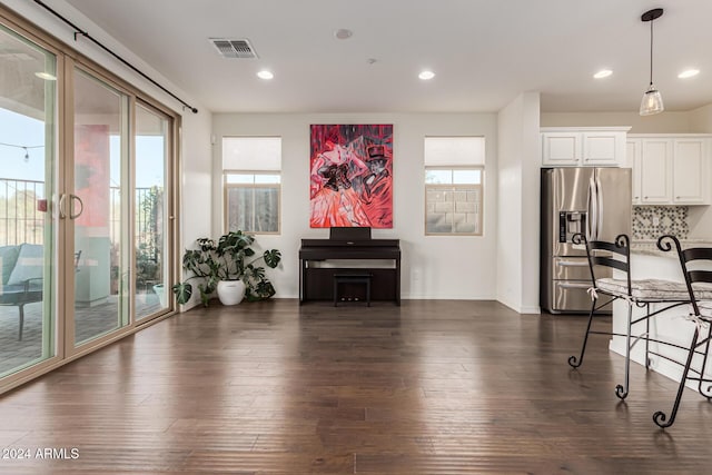 living room with dark wood finished floors, recessed lighting, and baseboards
