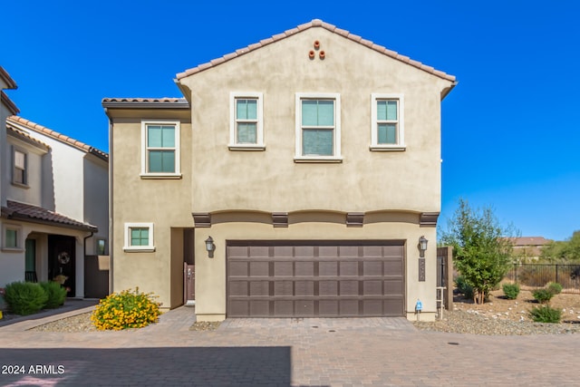 mediterranean / spanish-style home featuring a garage