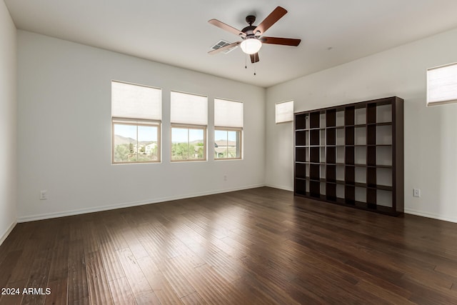 spare room with ceiling fan and dark wood-type flooring