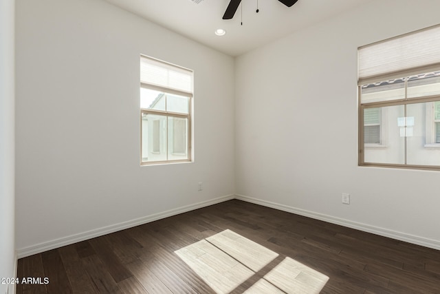 unfurnished room featuring ceiling fan and dark wood-type flooring