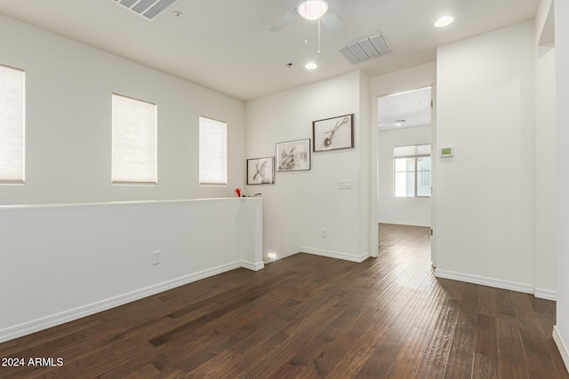 empty room featuring ceiling fan, dark wood finished floors, baseboards, and recessed lighting