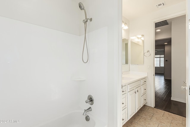 bathroom with shower / tub combination, vanity, and wood-type flooring