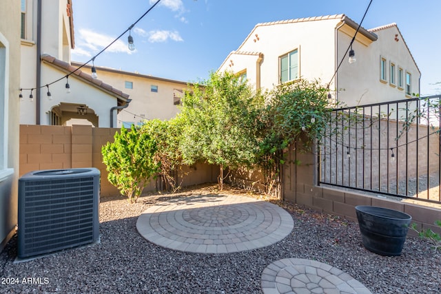 view of yard with central AC and a patio area