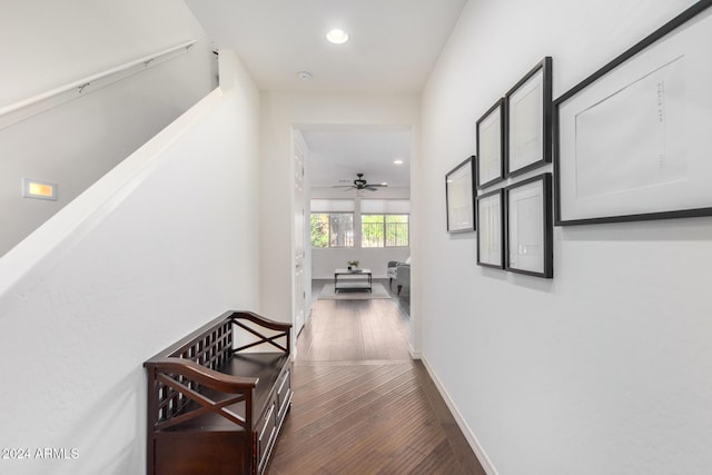 corridor with recessed lighting, hardwood / wood-style floors, and baseboards