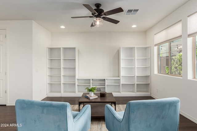 living room featuring dark hardwood / wood-style flooring and ceiling fan