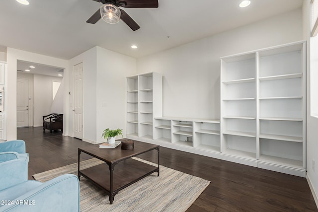 living room with ceiling fan and dark wood-type flooring