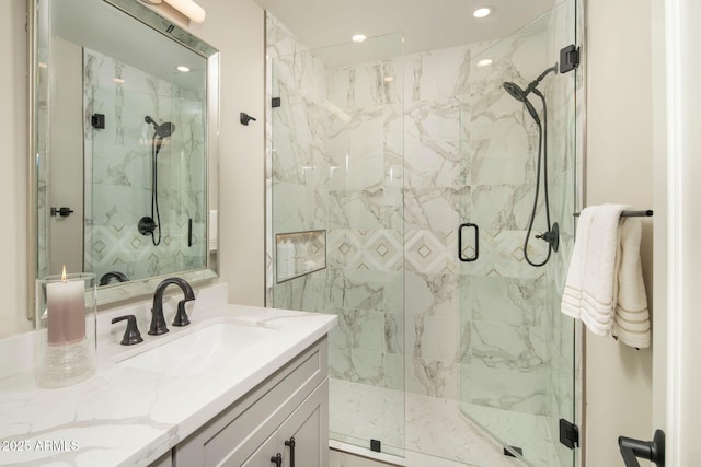 bathroom featuring vanity and an enclosed shower