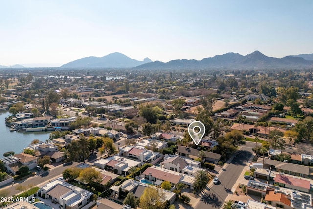 aerial view featuring a water and mountain view