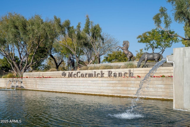 community sign with a water view