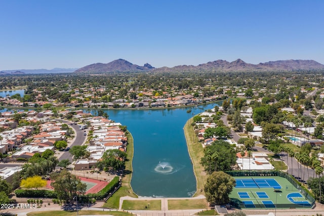 drone / aerial view with a water and mountain view