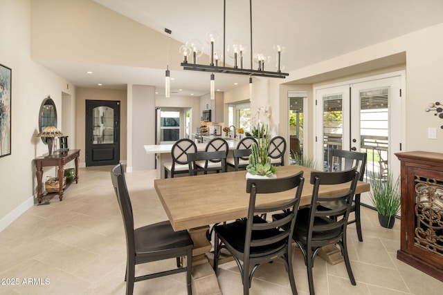 dining space featuring french doors, light tile patterned flooring, and vaulted ceiling