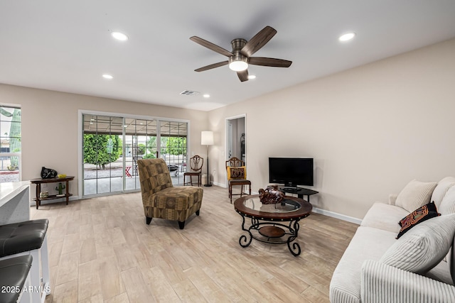 living room with visible vents, baseboards, light wood-type flooring, recessed lighting, and a ceiling fan