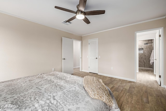 bedroom featuring crown molding, wood finished floors, visible vents, and baseboards