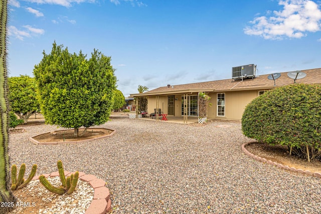 back of property featuring a patio and central AC