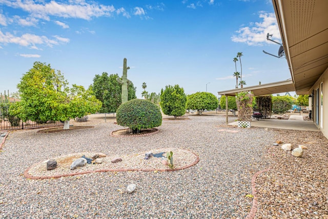 view of yard featuring a patio and fence