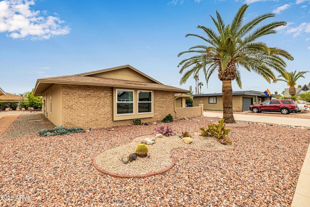 ranch-style house featuring brick siding