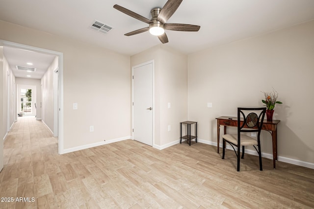 living area with visible vents, light wood-style floors, and a ceiling fan