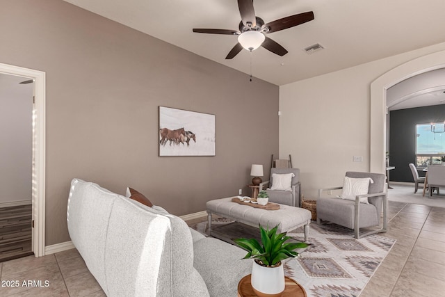 tiled living room with ceiling fan