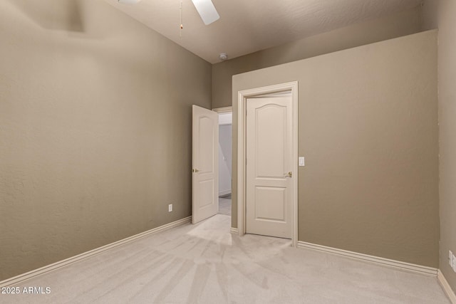 unfurnished bedroom with ceiling fan and light carpet