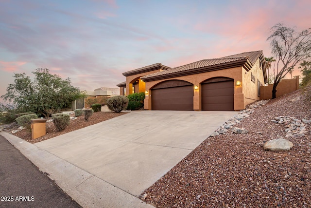 mediterranean / spanish-style home with a garage