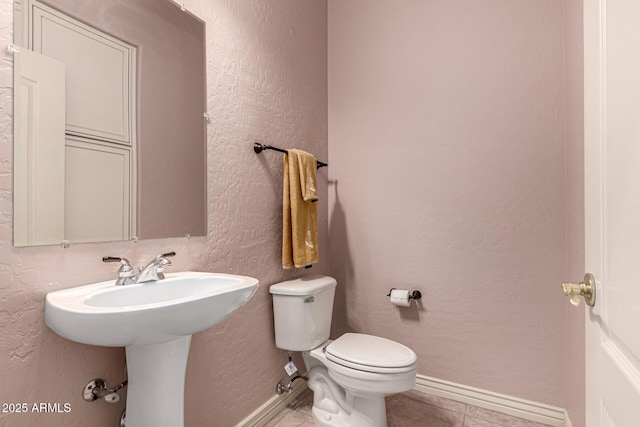 bathroom featuring tile patterned floors and toilet