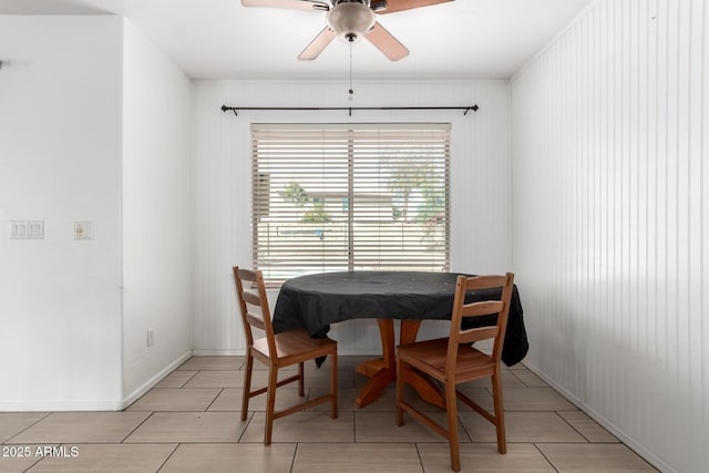 tiled dining space featuring ceiling fan