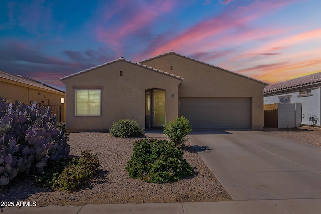 42406 W Posada Dr, Maricopa, AZ 85138 - mediterranean / spanish-style house featuring stucco siding, an attached garage, driveway, a tile roof, and fence