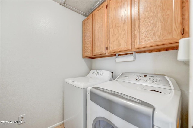 laundry room featuring cabinets and washing machine and dryer