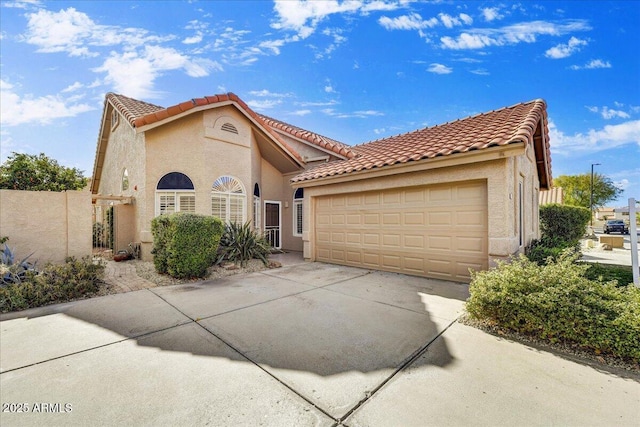 mediterranean / spanish home with a garage