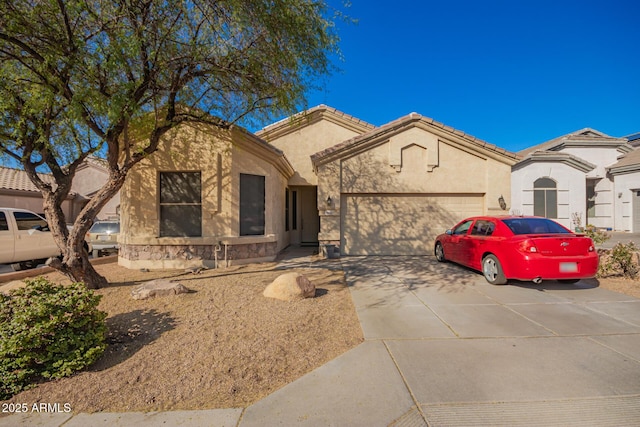 view of front facade featuring an attached garage, driveway, and stucco siding