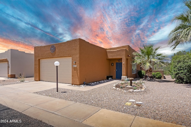 pueblo-style house with a garage