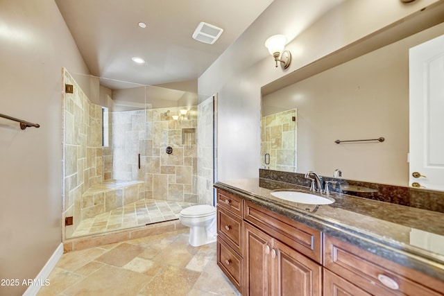 bathroom featuring vanity, toilet, and a shower with door