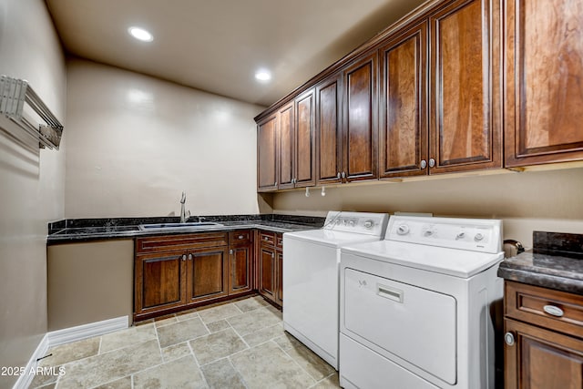 washroom featuring cabinets, sink, and independent washer and dryer