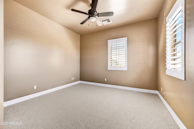 unfurnished room featuring ceiling fan and carpet