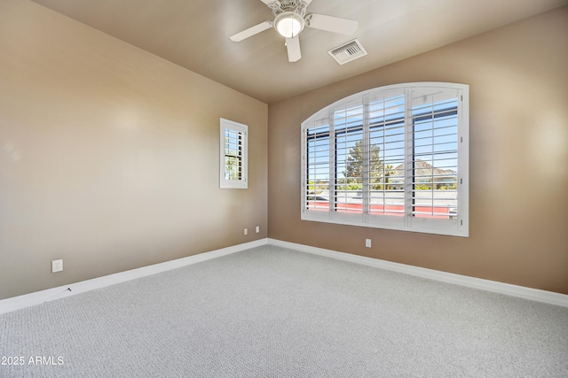 spare room with ceiling fan and carpet