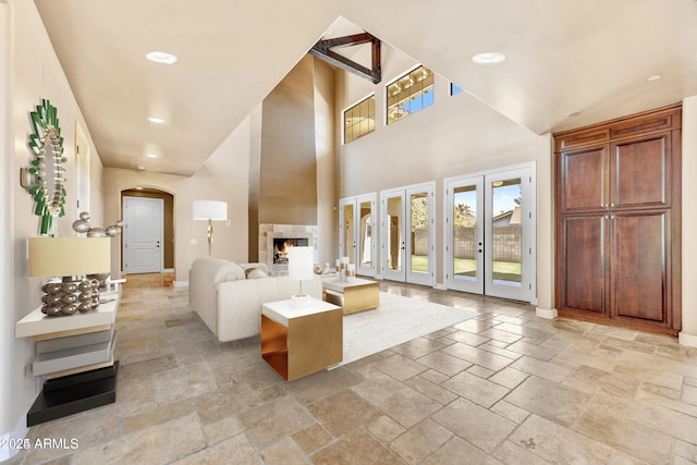 unfurnished living room with french doors and a high ceiling