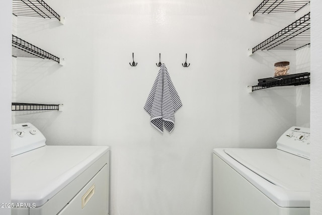 clothes washing area with laundry area and washer and clothes dryer