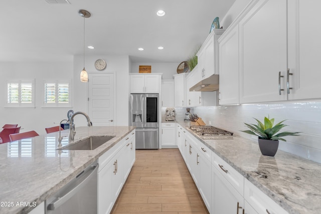 5637 S Parrish, Mesa, AZ 85212 - kitchen featuring stainless steel appliances, under cabinet range hood, tasteful backsplash, white cabinets, and light wood finished floors