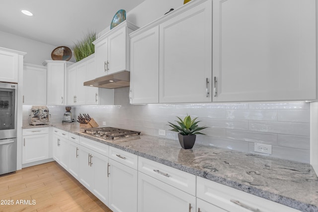 5637 S Parrish, Mesa, AZ 85212 - kitchen featuring stainless steel gas stovetop, under cabinet range hood, white cabinets, decorative backsplash, and recessed lighting
