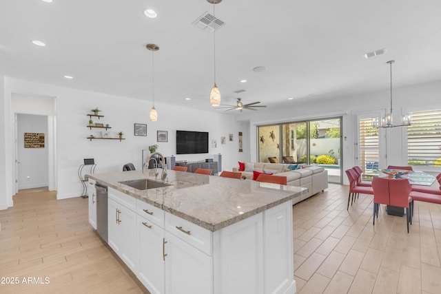 5637 S Parrish, Mesa, AZ 85212 - kitchen with stainless steel dishwasher, recessed lighting, white cabinetry, a kitchen island with sink, and hanging light fixtures
