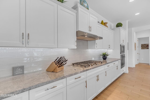 5637 S Parrish, Mesa, AZ 85212 - kitchen with under cabinet range hood, stainless steel appliances, white cabinets, decorative backsplash, and recessed lighting