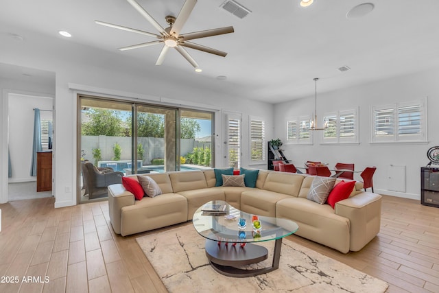 5637 S Parrish, Mesa, AZ 85212 - living room featuring light wood-style flooring, plenty of natural light, a ceiling fan, a chandelier, and recessed lighting