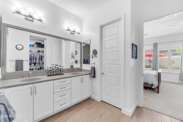 5637 S Parrish, Mesa, AZ 85212 - ensuite bathroom with double vanity, wood finished floors, and a walk in closet