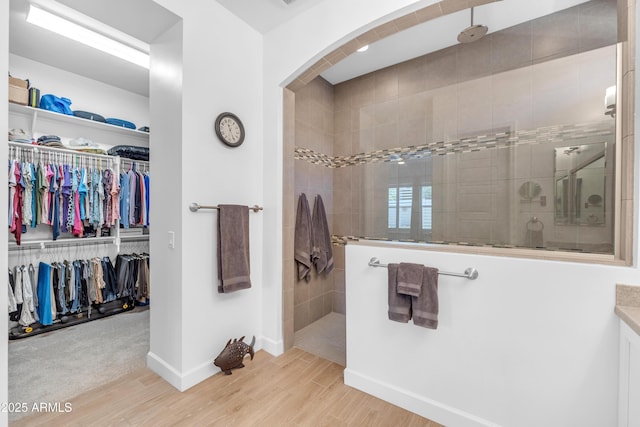 5637 S Parrish, Mesa, AZ 85212 - bathroom with wood finished floors, walk in shower, and a walk in closet