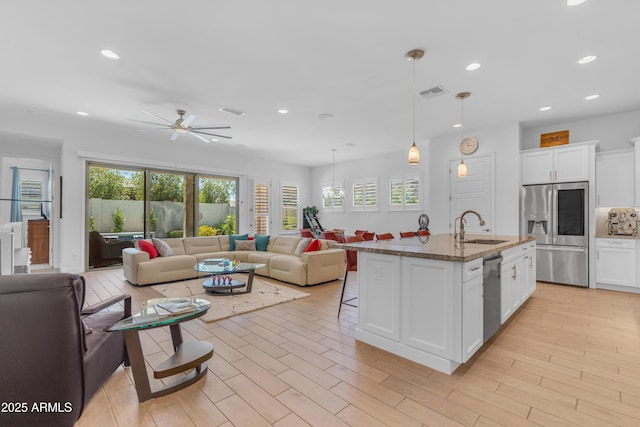 5637 S Parrish, Mesa, AZ 85212 - kitchen with appliances with stainless steel finishes, open floor plan, a kitchen bar, recessed lighting, and ceiling fan